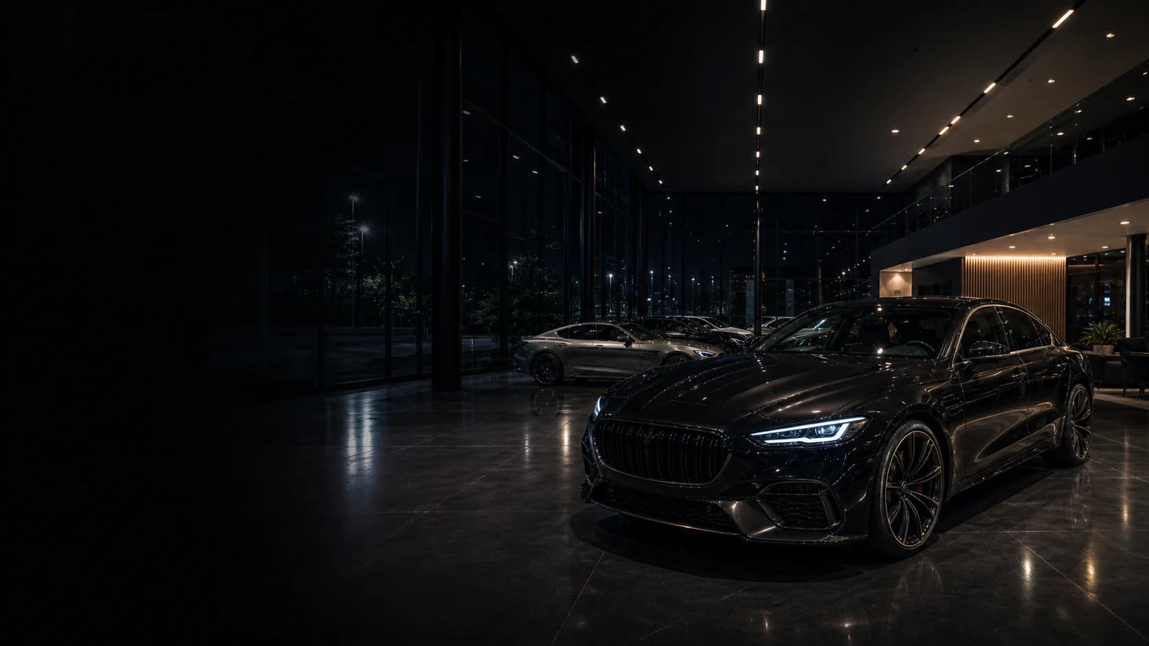 Luxury cars inside a premium showroom at night